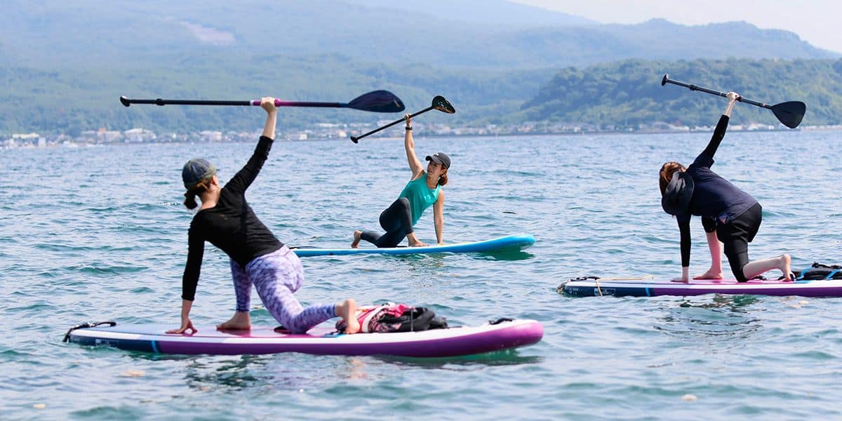 Sakurajima Volcano SUP Yoga Experience at Kagoshima Kinko Bay sup standup paddleboarding yoga wellness outdoor activity iso beach kagoshima kyushu japan